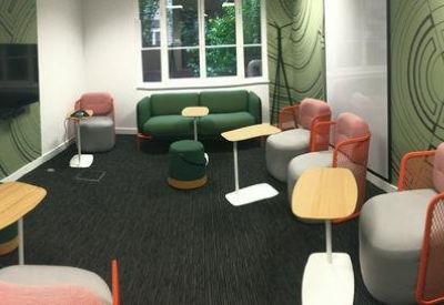 Lounge area with a dark sofa, pink armchairs, and circular patterned green wallpaper.