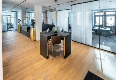 Sophisticated lounge area with a high black table and designer seating.