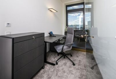 Private single-person office suite with a sleek grey desk and ergonomic chair.
