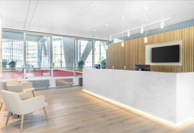 Clean white reception desk with a wood-paneled feature wall and warm lighting.