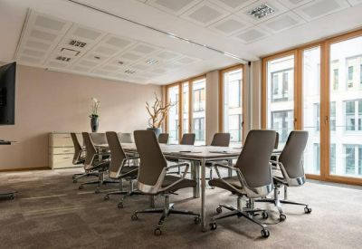 Spacious boardroom with a long table and floor-to-ceiling windows.