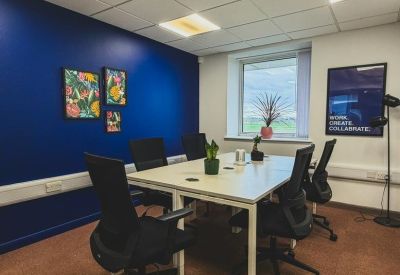 Small meeting room with artwork and potted plants