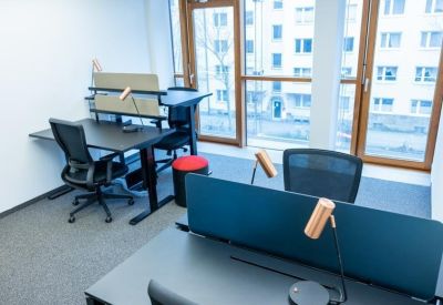 Workstation with dark desk and copper-toned task lamp.