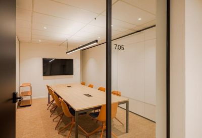 Corner with a coffee machine on an orange cabinet and shelves above.