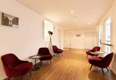 Professional meeting room with large windows and a long white table.