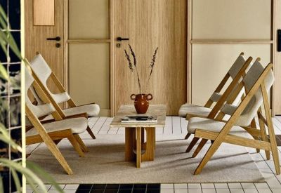 Modern lounge area with wooden chairs and a minimalist coffee table.