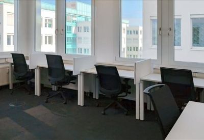 Professional three-person office with grey carpet and multiple windows.