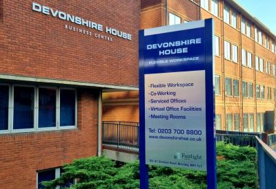 Exterior view of the brick facade and entrance signage at Devonshire House.