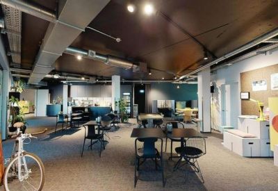 Spacious communal lounge with a bicycle and creative design elements.