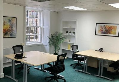 Small meeting room with four workstations.