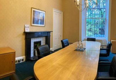 Conference room with a wooden table and fireplace.