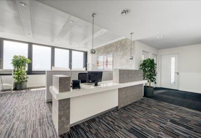 Professional reception desk with grey stone-textured accents and pendant lighting.