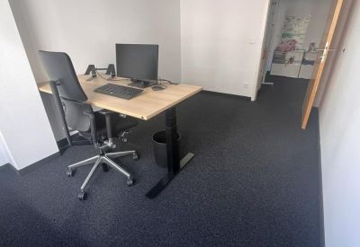 Private office suite with a height-adjustable desk and ergonomic task chair.