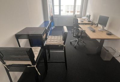 Bright workspace with dual desks and a high-top table for collaborative work.