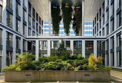 Coworking area with red dividers and modern pendant lights.