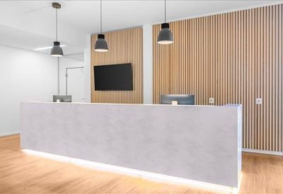 Reception area with modern counter and wood paneling.