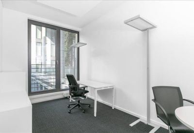 Compact office with desk and ergonomic chair.