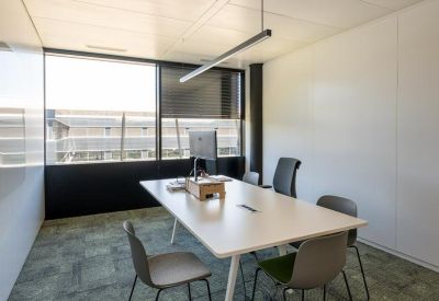 Small meeting room with table, chairs, and large window.