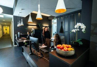 Professional reception desk with warm lighting and a bowl of fresh fruit.