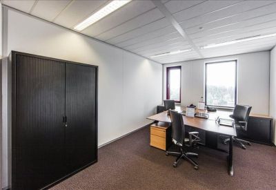 Private office suite featuring a dark wood storage cabinet and L-shaped desk.