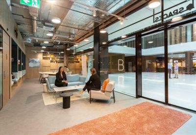 Bright lobby area with comfortable seating and views into a large courtyard.