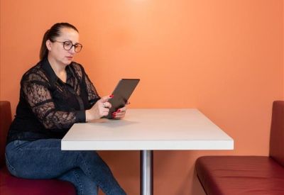 Spacious workspace with multiple workstations and wooden-framed windows.