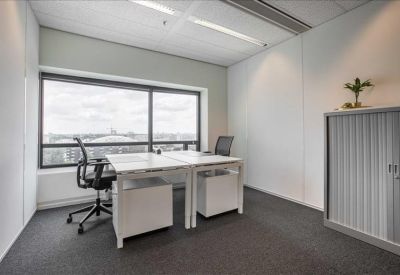 Private two-person office suite featuring white desks and a large window with city views.