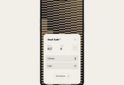 Smartphone displaying a digital building management app for climate and light control.