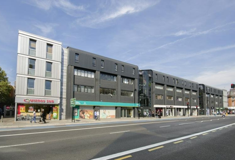 Exterior view of the modern grey and silver facade at Whitechapel Technology Centre.