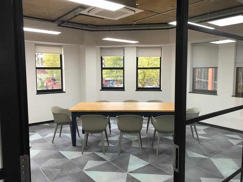 Meeting room at The Quorum, Bond Street, Bristol with a large wooden table and geometric patterned carpet.