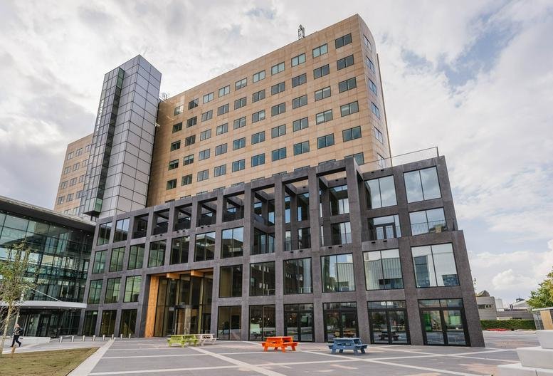 Exterior view of the modern stone and glass facade at 30, Basisweg, Amsterdam.