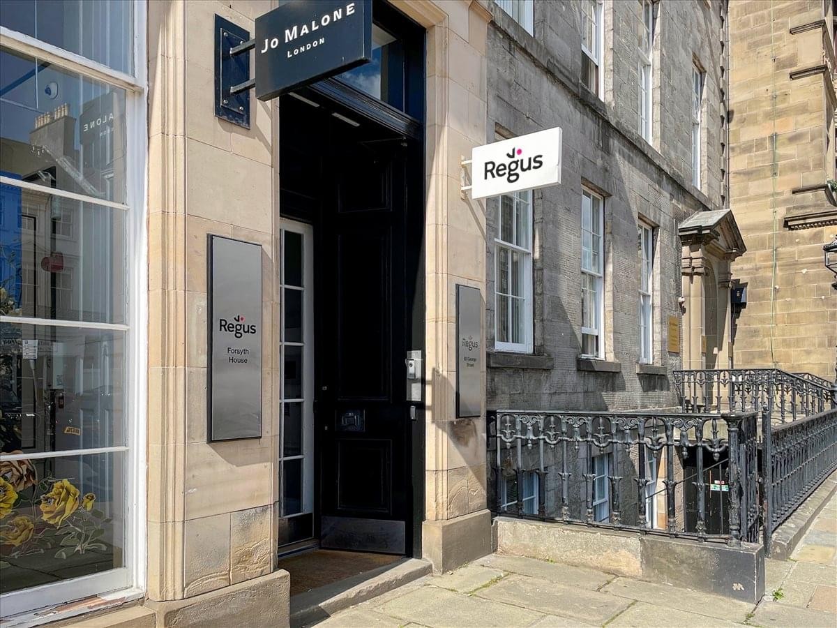 Street entrance to 93 George Street, Edinburgh, with branded signage and classic stone architecture.