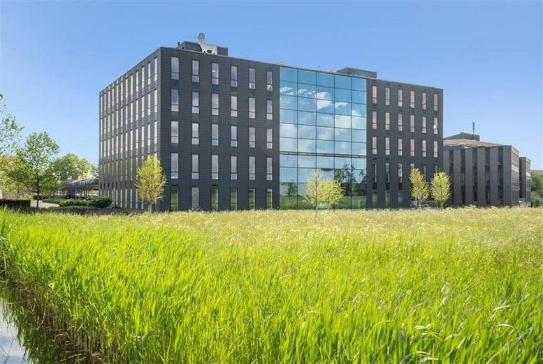 Exterior view of the dark brick and glass office building at Flemingweg 8, Alphen aan den Rijn.