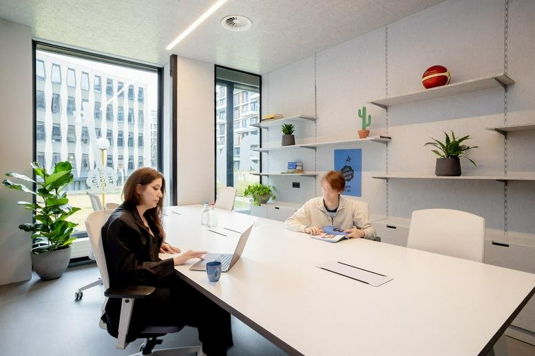 Bright open-plan office at Jan van Galeenstraat 335, Amsterdam, North Holland with white desks and shelving.