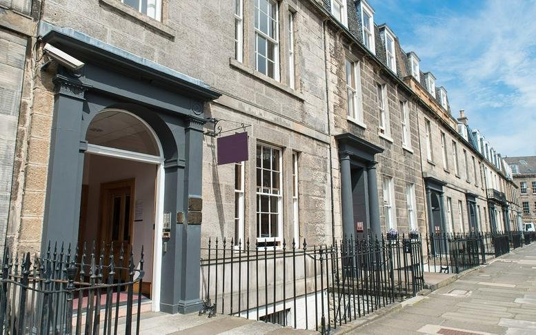Exterior view of the stone facade and entrance at 16-26 Forth Street, Edinburgh, Scotland.