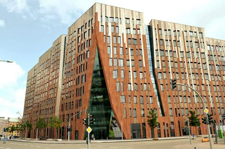 Exterior view of the modern brick and glass building at Überseeallee 1.