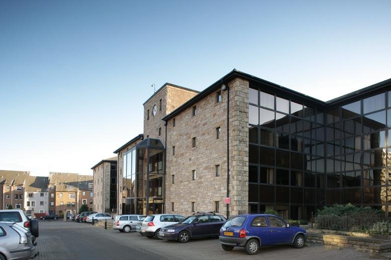 Exterior view of the stone-clad and glass facade of Bonnington Bond.
