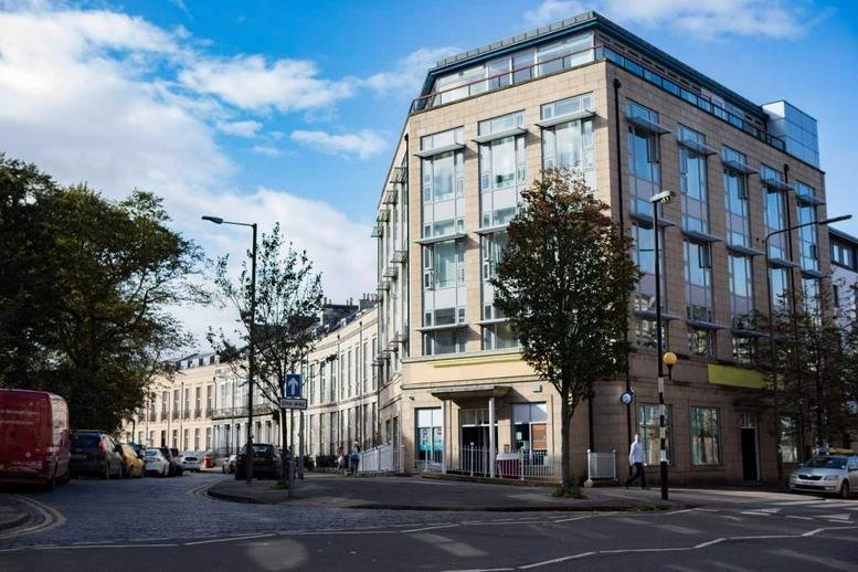 Exterior view of the contemporary stone and glass facade of Hopetoun Gate, 8b McDonald Road.