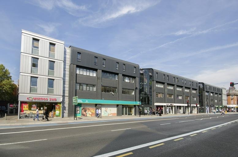Exterior view of the modern grey and silver facade at Whitechapel Technology Centre.