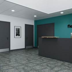 Professional reception area with a dark grey desk and a prominent teal feature wall.