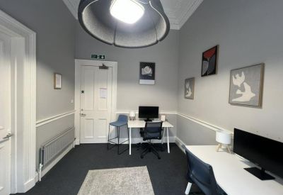 Small office with two desks and modern decor.