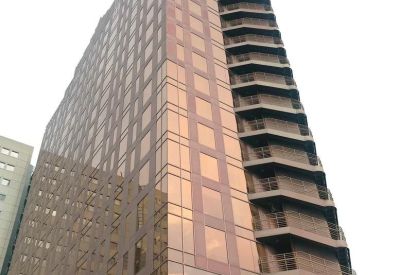 Exterior view of the glass-facade Av. Burgos, 8A building at dusk.