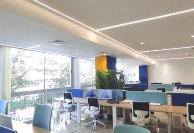 Bright office space with natural light from large windows and ergonomic seating.