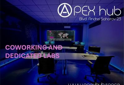 Dimly lit tech lab with blue neon accents and multiple monitor workstations.