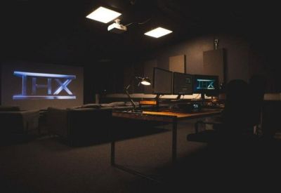 Media suite with a large projector screen and workspace.