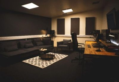 Lounge area with a dark sofa and geometric patterned rug.