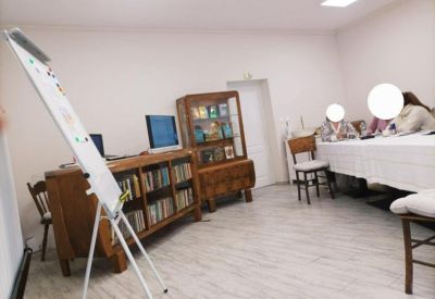Meeting room at J. Kuri, Varna, Bulgaria with a whiteboard, wooden bookshelves, and a long table.