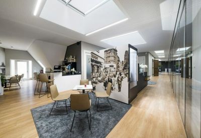 Modern breakout area with a large wall mural and skylights providing natural light.