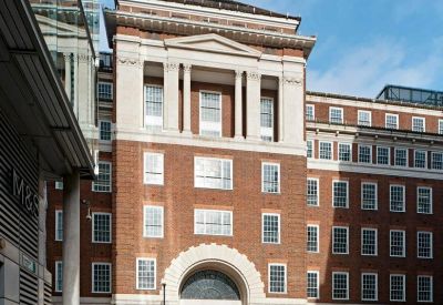 Exterior brick and stone facade of One Lackington Street, London featuring a large arched entrance.