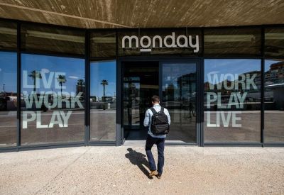 Entrance with glass doors featuring company branding and slogans.